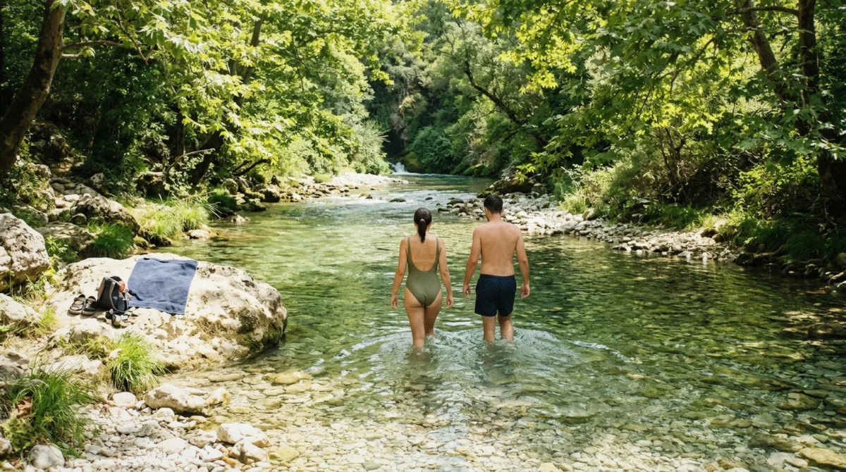 Visitors wading into the clear river below the Blue Eye Albania spring, the spot where swimming near the Blue Eye is actually permitted